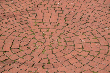 Paving in park of red brick ceramic pavers closeup as background