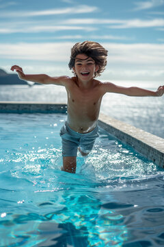 A boy jumping into infinity pool in front of the turquoise sea