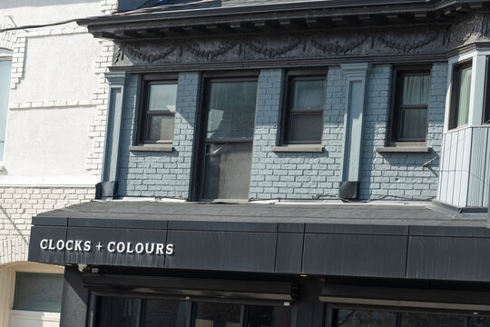 exterior building facade and sign of Clocks and Colours, a fashion accessories store, located at 154 Ossington Avenue in Toronto, Canada