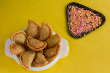 Gujia or Gujiya is a traditional Indian sweet or dessert made during Holi ,Diwali Festival.Resembles Spanish Empanada is deep fried or baked.Made from floor,milk solids,sugar,raisins,semolina.Closeup.