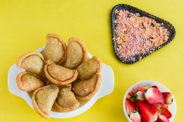 Gujia or Gujiya is a traditional Indian sweet or dessert made during Holi ,Diwali Festival.Resembles Spanish Empanada is deep fried or baked.Made from floor,milk solids,sugar,raisins,semolina.Closeup.