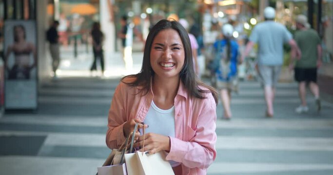 Happy woman close-up shopping mall showing bags her face radiating with pleasure. Pleasure shopping joy her smile Shopping pleasure reflects her elegance genuine emotions Celebration style.