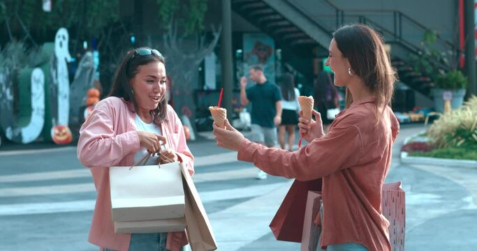 City street women enjoy frozen food showcasing pleasure from ice cream. Pleasure from ice cream moment of happiness bonding Pleasure from ice cream blend of taste joyful companionship.