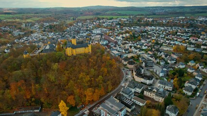 Fototapeta na wymiar Aerial view of the old town around the city Montabaur on an overcast day in fall in Germany. 