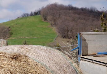 Hay bales unloaded from a truck in a mountainous countryside area - 759820362