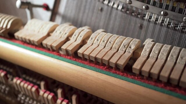 Close-up of piano hammers inside, gavel of the string open mechanism.