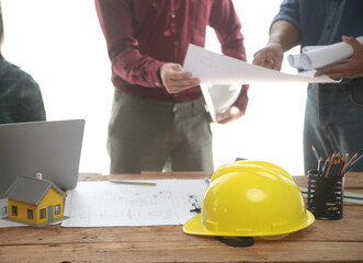 Diverse Team of Specialists Use Laptop on Construction Site. Real Estate Building Project with Engineer Investor and Businessman Checking Area, working on Civil Engineering, Discussing Strategy Plan