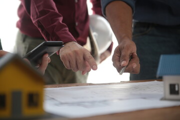 Diverse Team of Specialists Use Laptop on Construction Site. Real Estate Building Project with...
