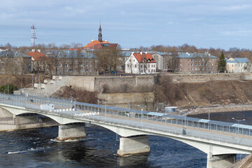 Border Friendship Bridge in the city landscape on a March day. Narva, Estonia - 759851326