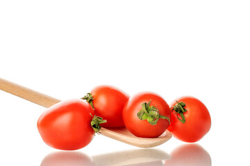 Several ripe cherry tomatoes with a wooden spoon, macro, isolated on white background.