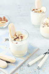 Milk mousse dessert with nuts in glasses	
