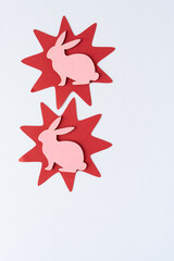 machine-cut red paper stars with pink bunny silhouettes