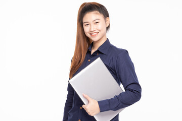 Cheerful Asian businesswoman in a navy shirt holding a laptop, standing against a white backdrop