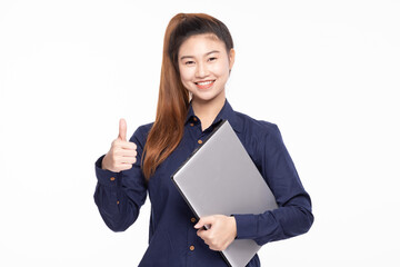 Smiling Asian businesswoman in navy blue shirt holding a laptop and giving a thumbs up gesture