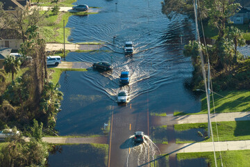Flooded road in Florida after heavy hurricane rainfall. Aerial view of evacuating cars and...