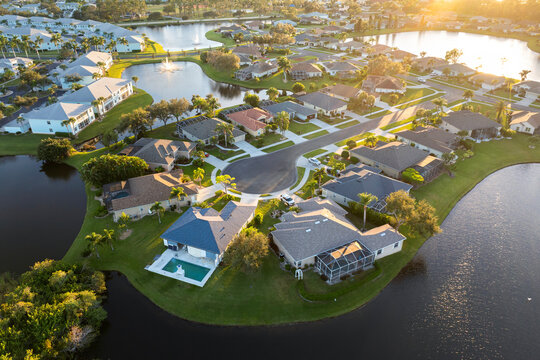 Low-density private homes at sunset. Rural street cul-de-sac dead end in residential suburbs with upscale suburban houses outside of Sarasota, Florida