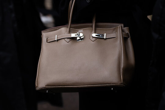 Paris, France - January, 25, 2024: woman wears Hermes Birkin handbag, street style details