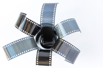 Different pieces and rest of 35 mm photography film, analog or chemical photography, on a white background. 35mm Red Negative Photo Film Stripes Frame Gritty Scan Pieces.