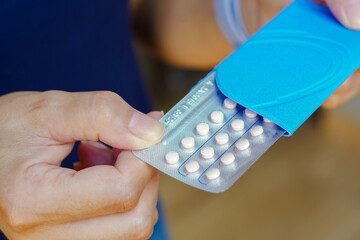 A woman holds her birth control pill. In Brazil, contraceptives must only be sold under medical prescription. A woman must undergo complete medical examinations before using the medicine.