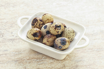 Raw quail eggs heap in the bowl