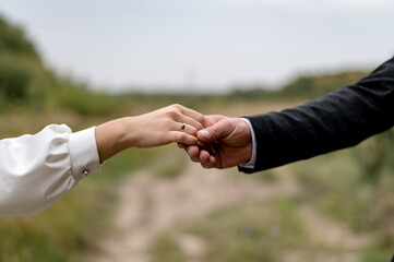 Hands of newlyweds with wedding rings