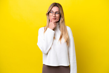 Young Uruguayan woman isolated on yellow background looking to the side and smiling - 759881591