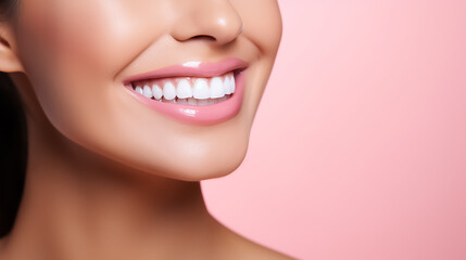 Beautiful healthy white smile on a pink background, close-up photo of a young woman's face. Image for a dental clinic with copyspace.