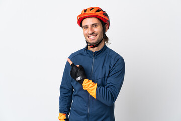 Young cyclist man isolated on white background pointing to the side to present a product - obrazy, fototapety, plakaty