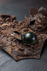 Box of assorted chocolates on dark background. Top view.