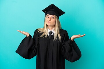 Young university graduate over isolated blue background having doubts while raising hands