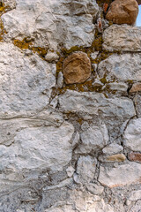 Background. An ancient wall made of archaically processed stone. The wall of the ancient building is made of stones.