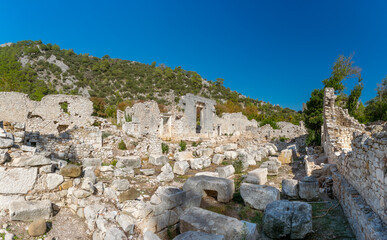 Fototapeta na wymiar Picturesque ruins of the ancient city of Olympos, in Turkey. Ruins of the ancient city of Olympos near the village of Cirali in Turkey.