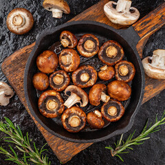 Fototapeta na wymiar Perfectly Grilled Mushrooms in a cast iron skillet seasoned with Worcestershire sauce, butter, garlic, rosemary, olive oil, salt and red wine