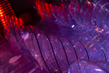 Illuminated Purple Plastic Chairs Stacked in Switzerland.
