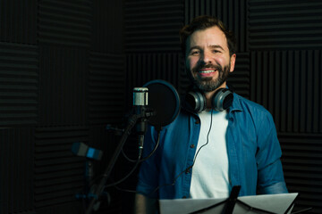 Smiling male voiceover artist in recording studio