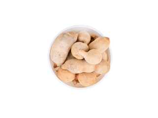 Tamarind fruit in shell and bowl isolated on white background, top view