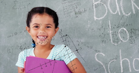 Image of math formulas over happy biracial girl holding books