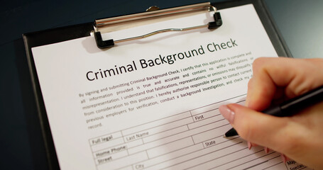 Hand Filling Criminal Background Check Application