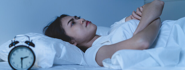 Anxiety disorder on insomnia woman concept, sleepless Woman open eye awakening on the bed at night...