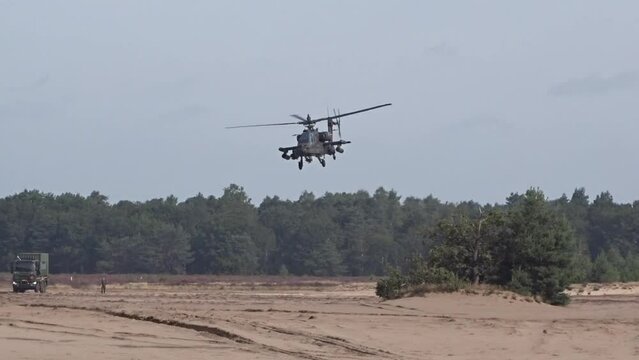Military Helicopter flying low between trees