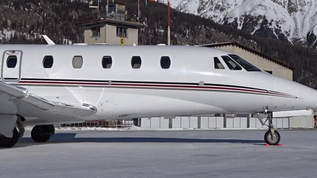 Slow panning shot of Business Jet parked at Airport Snow