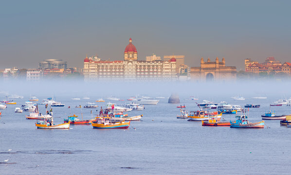The Gateway of India and boats in the background Taj Mahal Hotel - Mumbai, India