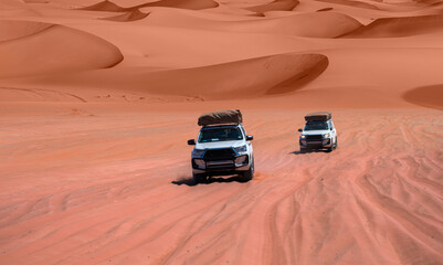 4X4 Suv vehicle rides through the sand dune Namib desert - Namibia