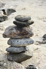 Fototapeta na wymiar Sandy Beach with a Stack of Rocks