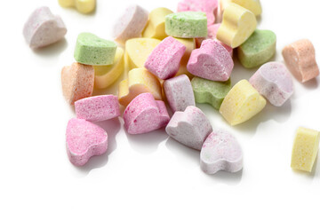 Pink and purple heart shaped candies. Valentine's day background.