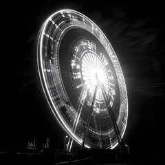 a black and white photo of a ferris wheel at night
