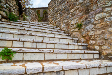 Old marble staircase. Exterior Spiral Stairs With Marble Stone Steps in a traditional village