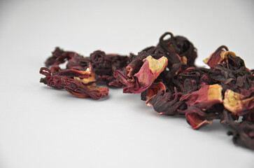 Egyptian hibiscus dry red tea (karkade) aligned pile (line), closeup (macro) isolated