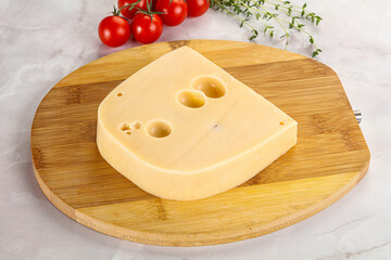 Maasdam cheese brick over board