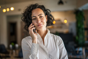 One woman mature caucasian female businesswoman entrepreneur stand at work or home use mobile phone...